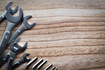 Top view wooden table, Steel wrench and hexagon keys pile on the left with copy space.