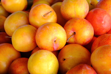 Yellow plum food background top view