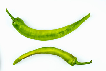 Two hot green peppers isolated on a white background.