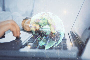 Social network theme hologram with businessman working on computer on background. Concept of world...