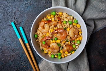 A traditional dish of Asian cuisine. Rice with shrimps, green onion and yellow corn