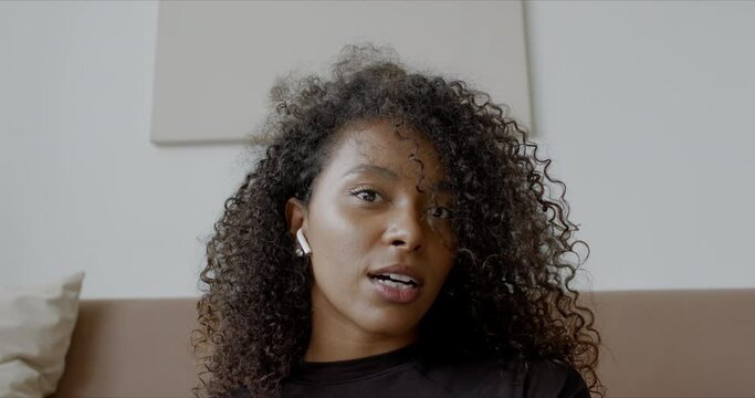 POV WEBCAM VIEW Young adult Black African American female having a video conference call at home. 60 FPS slow motion 4K UHD RAW Graded footage