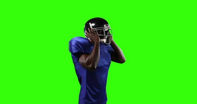 African American football player on green screen background.
