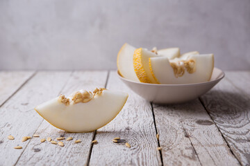 Melon, juicy melon wedges, sliced ​​on a light table, background image
