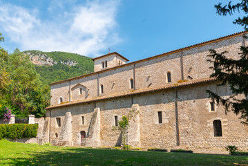 Fototapeta na wymiar Sermoneta, Italy. June 28th, 2020. Valvisciolo Abbey. External side facade. The abbey is located at 116 m a.s.l. on a buttress overlooking a small valley, traditionally medieval, called 