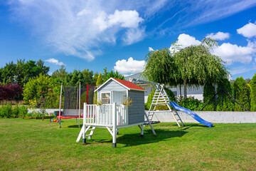 A beautiful wooden house for children and a garden playground