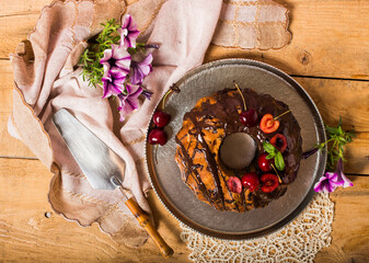 homemade cake decorated with cherries and chocolate glaze