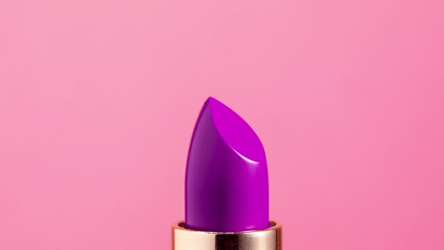 Close up video of red lipstick rising 