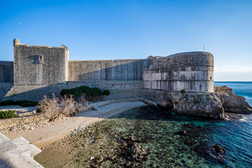 Fortress from outside, clear blue-sky sunny day. Scenery winter view of Mediterranean old city of Dubrovnik, famous European travel and historic destination, Croatia
