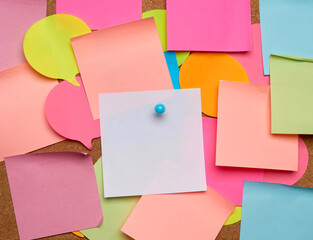 colorful paper stickers glued on brown balsa board, idea and multitasking