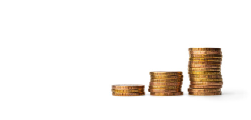 money, yellow metal coins stacked in columns on a white background, isolate