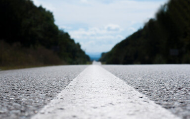 Asphalt road. Road markings. Close up from below