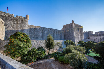 Fototapeta na wymiar Fortress from outside, clear blue-sky sunny day. Scenery winter view of Mediterranean old city of Dubrovnik, famous European travel and historic destination, Croatia