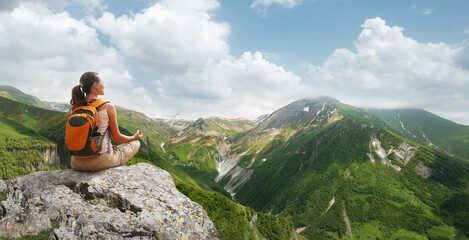 Woman meditating yoga in the mountains sunny Georgia(country). Travel Lifestyle relaxation emotional concept adventure summer vacations. - obrazy, fototapety, plakaty