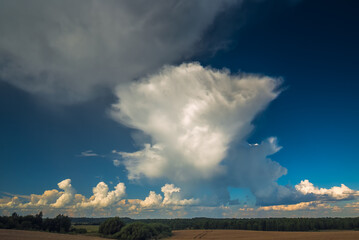 Fototapeta na wymiar Cumulonimbus storm clouds in evening light with sun rays