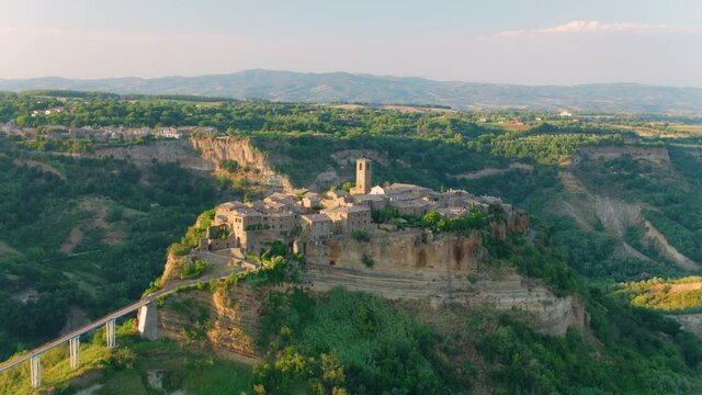 Aerial footage of medieval city on the rock,  Civita di Bagnoregio  illuminated by setting sun. Italy. Apple ProRes codec.