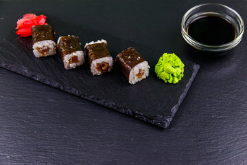 Sushi maki rolls with tuna on black slate