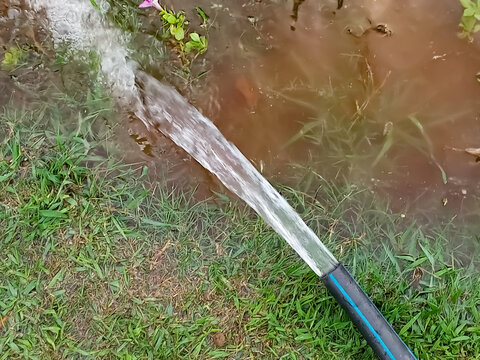 Water Flowing Through The Pipe In The Garden