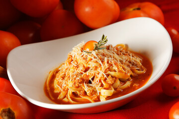 Noodles in tomato sauce and parmesan cheese.