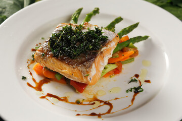 Smoked salmon with chimichurri and vegetable garnish with pumpkin, carrot, broccoli and asparagus.