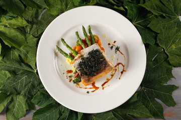 Smoked salmon with chimichurri and vegetable garnish with pumpkin, carrot, broccoli and asparagus.