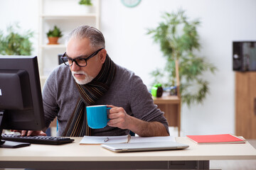 Fototapeta premium Old male employee working from house during pandemic