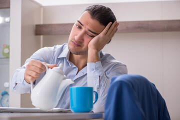Young male employee working from the house