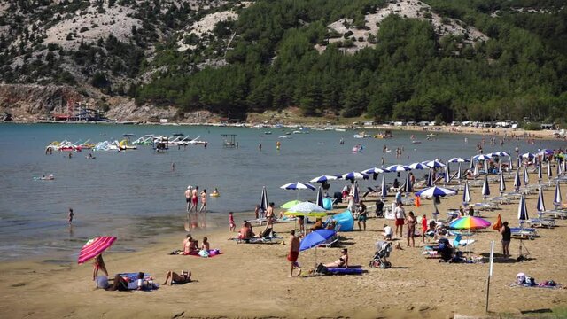 At the large sandy beach in Lopar on the island of Rab, many people always come to bathe in the sea or in the sun.