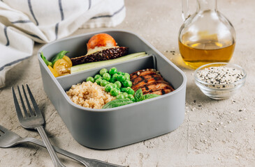 Healthy lunch in plastic containers with quinoa and chicken.