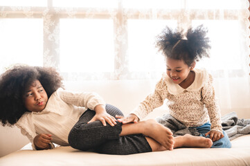 African American children playing together on the bed at home, cute little children jumping on bed
