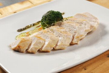 Grilled chicken breast with pumpkin, carrot and broccoli, garnished with chimichurri.