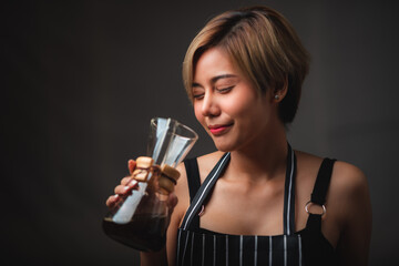 Professional female barista smiling, portrait of young female coffee maker in the cafe