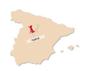 A paper map of Spain, with a pin in the location of Madrid, the name stuck on with tape.