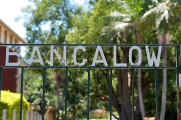 White Bangalow inscription on a weathered iron gate