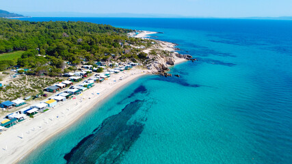 Aerial view of the sea and camp houses on the beach 