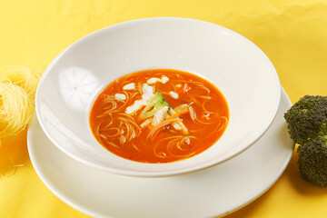 Noodle soup with chicken and tomato.
