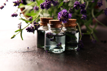 Glass bottle of Lavender essential oil with fresh lavender flowers for healthy aromatherapy spa...