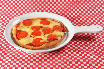 Traditional Italian pizza with tomato sauce, ham, pineapple and pepperoni.