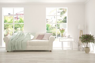 White living room with sofa and summer landscape in window. Scandinavian interior design. 3D illustration