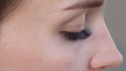 Concept of beauty and fashion. Banner women's eyes with long false eyelashes. Macro snapshot.