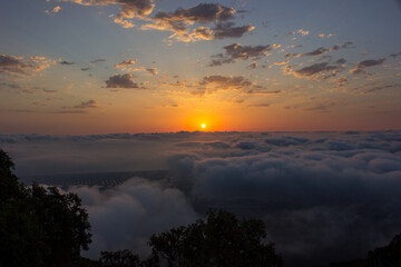 
sunrise above the clouds on a mountain