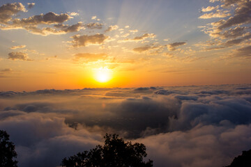 
sunrise above the clouds on a mountain