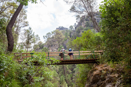 Tourists standing on a bridge over Borosa River