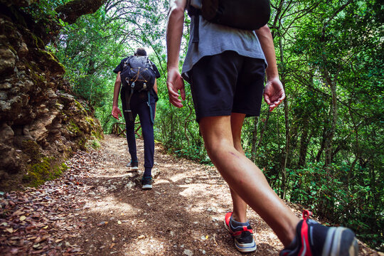 Young friends walking on a path along the Borosa river in the Natural Park of the Sierras de Cazorla