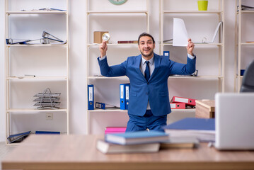 Young male employee unhappy with excessive work