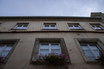 Fototapeta na wymiar Old house with flowers from below in Czech Republic