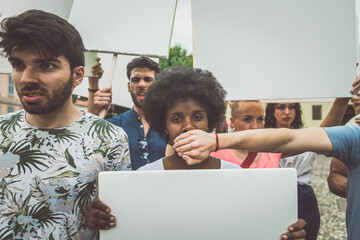 Public demonstration on the street against social problems and human rights. Group of multiethnic...