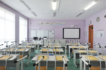 classroom without students - educational class with study desks and overturned chairs