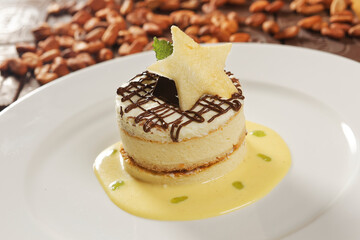 Vanilla dessert with custard, chocolate and star-shaped biscuit.