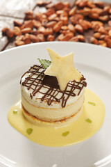 Vanilla dessert with custard, chocolate and star-shaped biscuit.